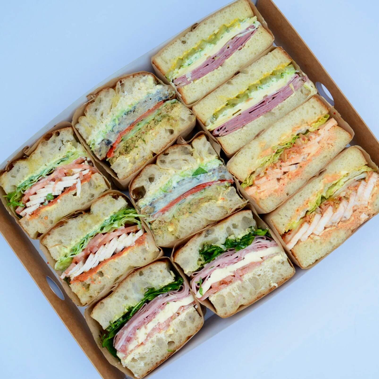 open catering box full of sandwiches